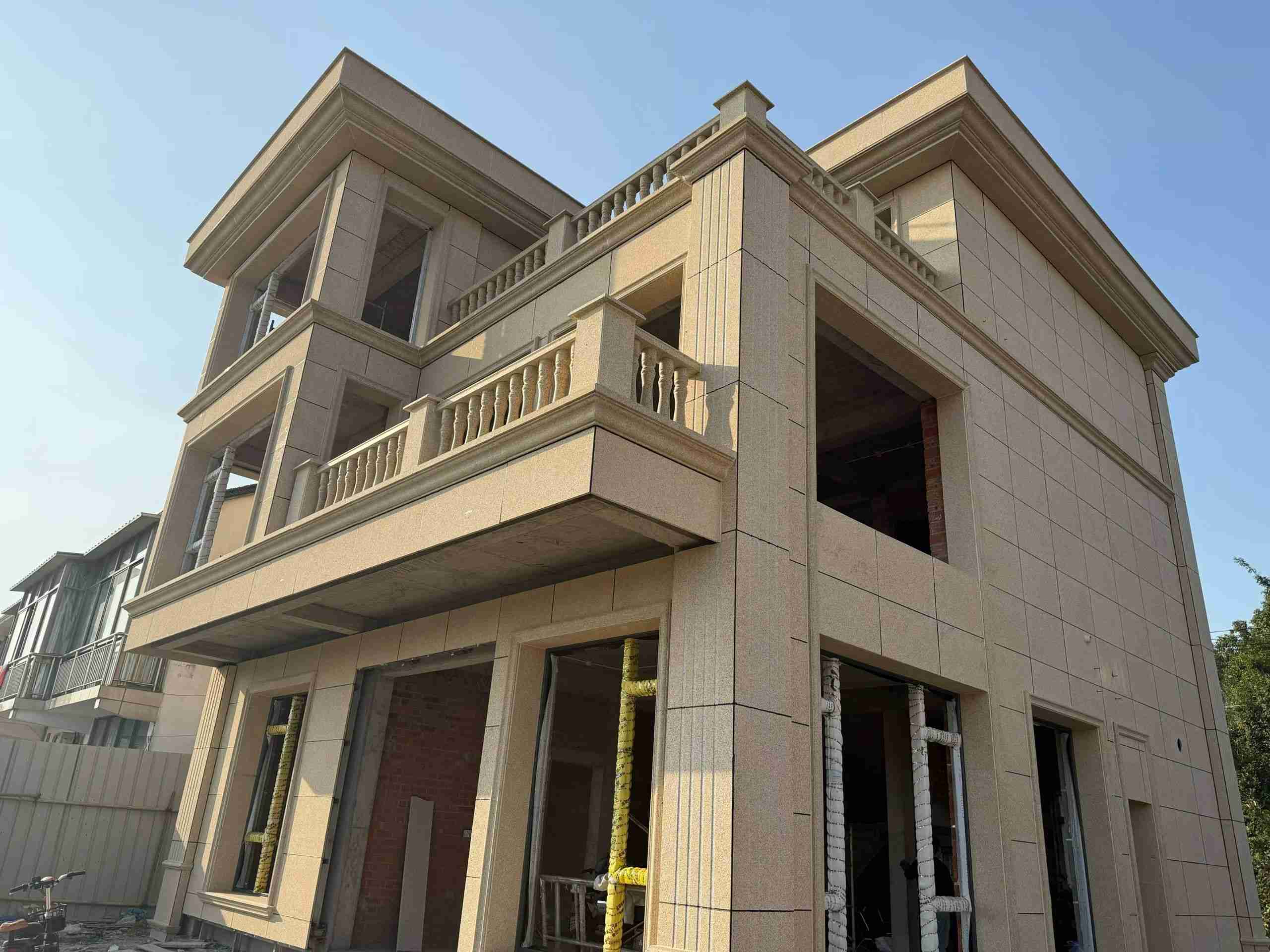 日喀则布 黄金麻花岗岩石材荔枝面外墙干挂效果展示